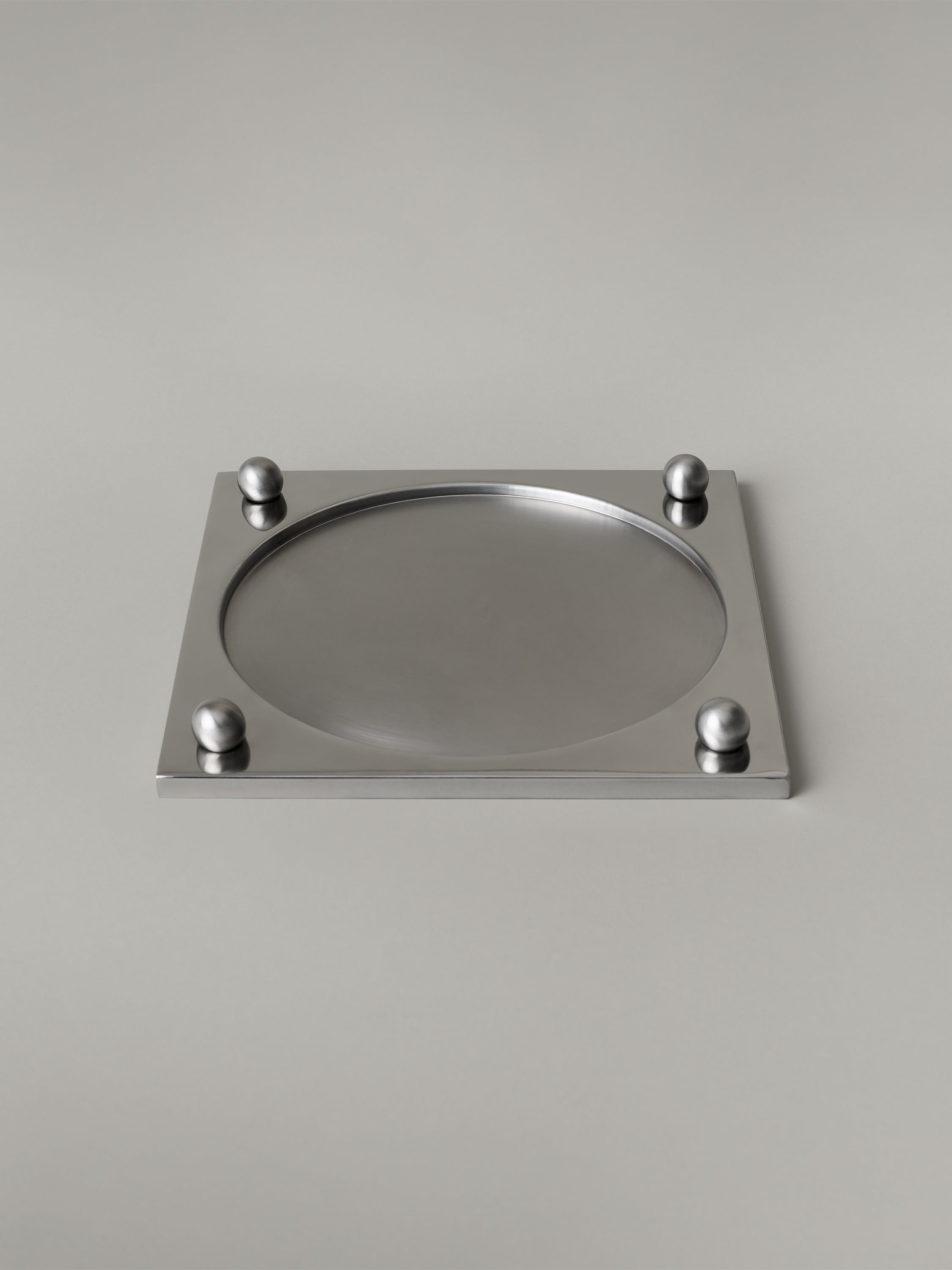 Stainless steel serving tray with a recessed brushed center and polished rim