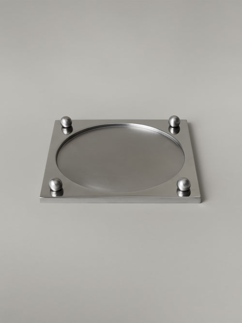Stainless steel serving tray with a recessed brushed center and polished rim