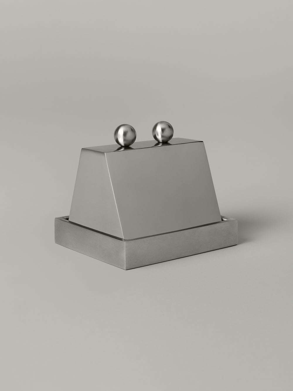 Stainless steel butter dish with a domed cloche lid, brushed and polished finishes