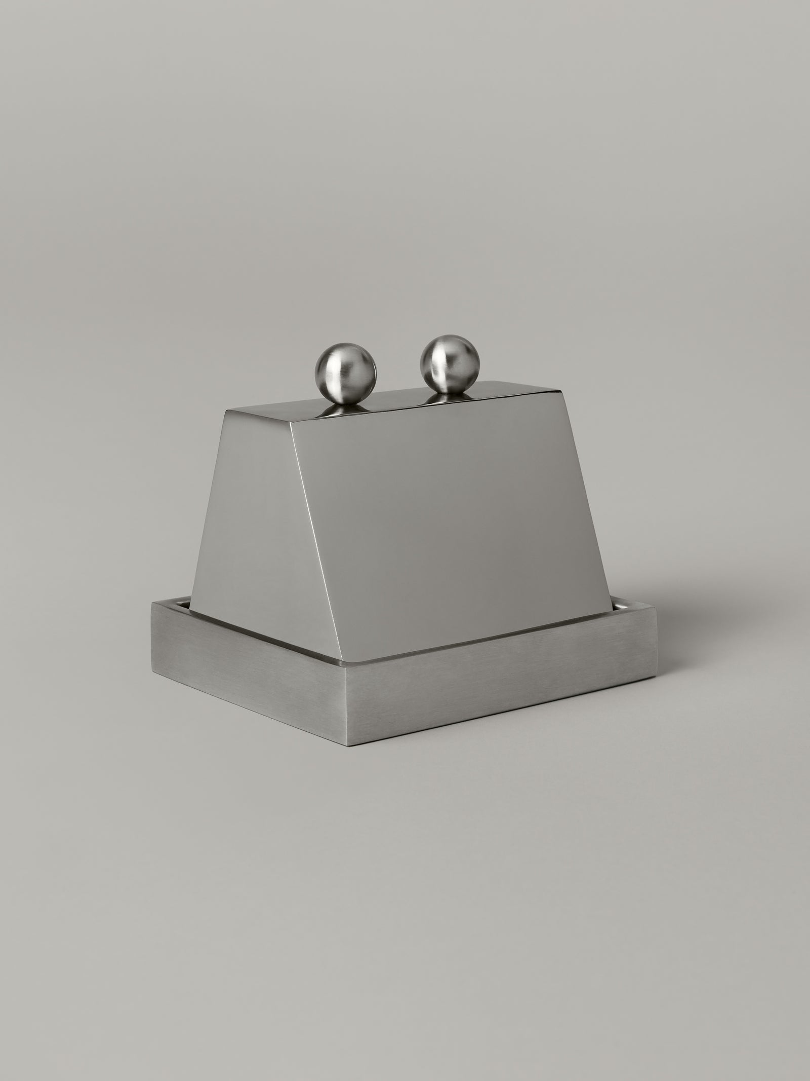 Stainless steel butter dish with a domed cloche lid, brushed and polished finishes