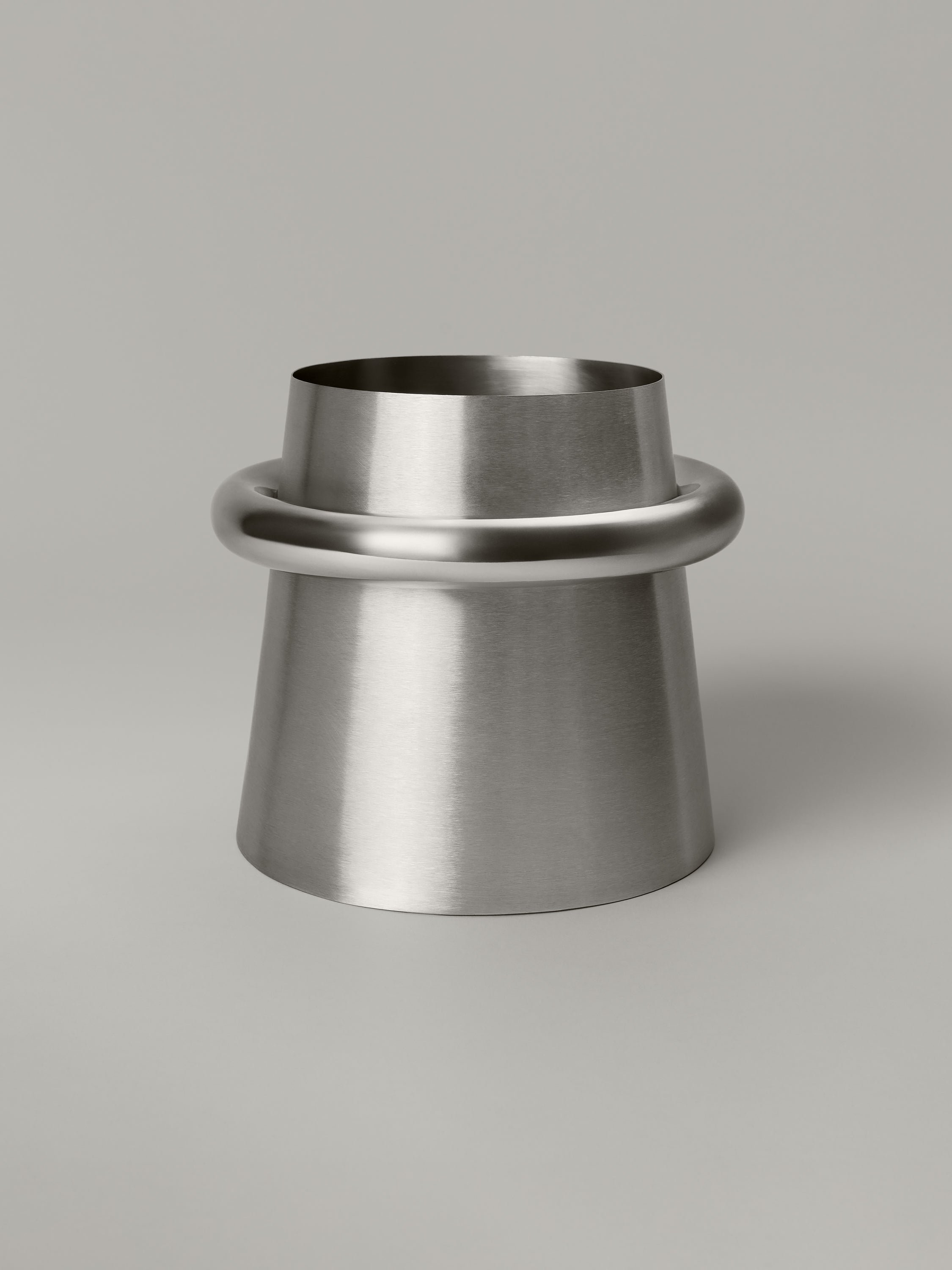 Stainless steel waste bin with a brushed body and polished ring at the rim