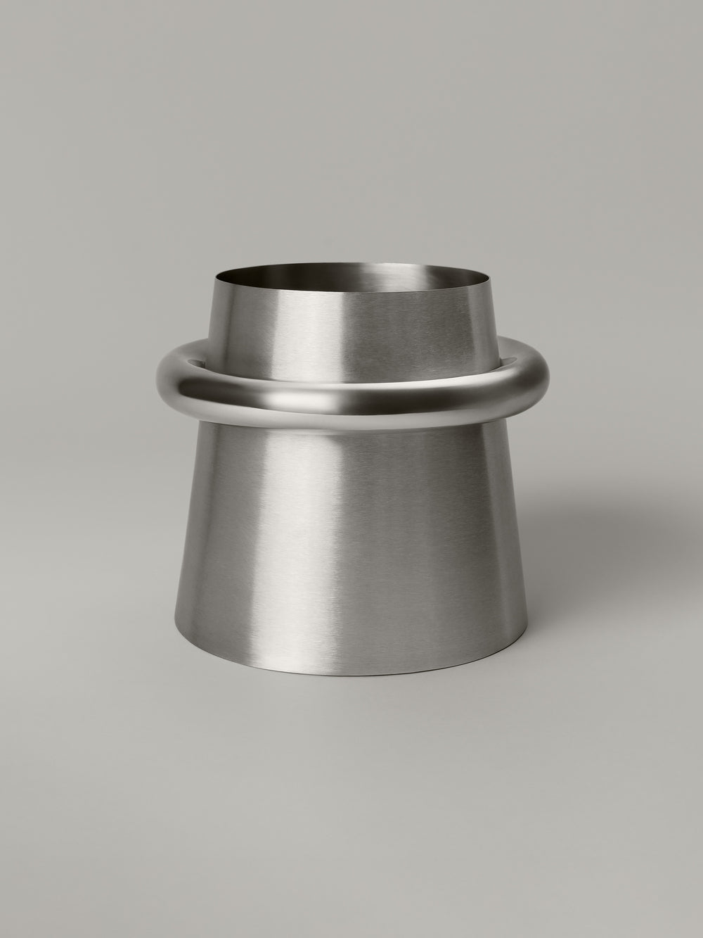 Stainless steel waste bin with a brushed body and polished ring at the rim