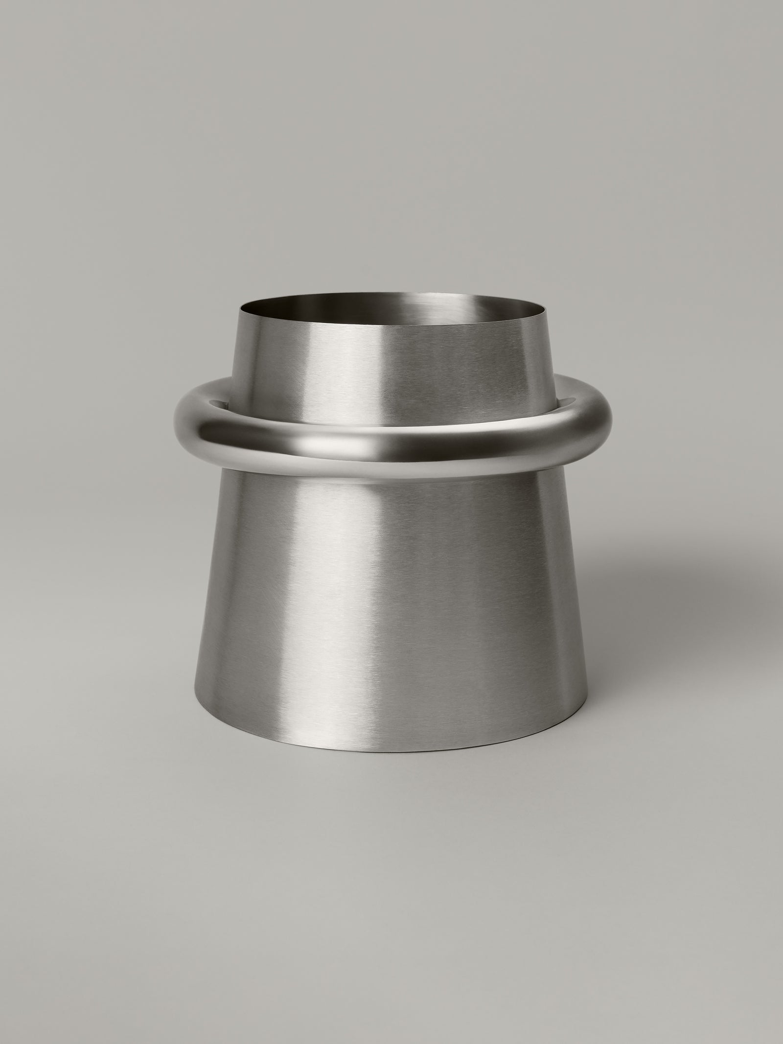 Stainless steel waste bin with a brushed body and polished ring at the rim